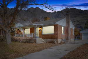 View of front of property with a mountain view and covered porch