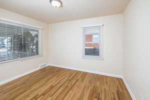 Unfurnished room with hardwood / wood-style flooring