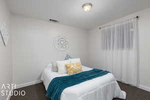 Carpeted bedroom 4 with a textured ceiling