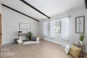 Living area with  wood-style floors and lofted ceiling with beams