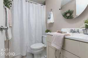 Bathroom with vanity, a textured ceiling, toilet, and tile patterned flooring