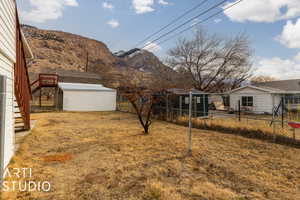 View of yard featuring a mountain view and an outbuilding