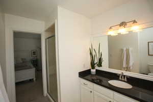 Bathroom featuring vanity and a shower