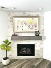 Interior details with hardwood / wood-style floors, a fireplace, and a textured ceiling