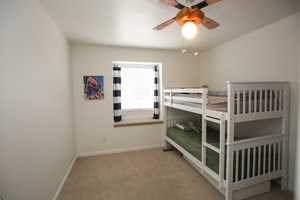 Bedroom featuring ceiling fan and light colored carpet