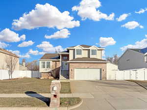 Tri-level home with a garage and a front lawn