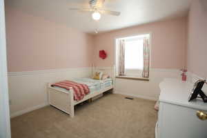 Carpeted bedroom with ceiling fan