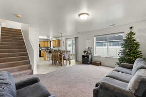 Carpeted living room with a textured ceiling