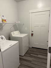 Washroom featuring dark hardwood / wood-style floors and washer and clothes dryer