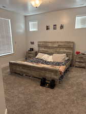 Carpeted bedroom with a textured ceiling