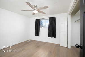 Unfurnished bedroom with light hardwood / wood-style flooring and ceiling fan