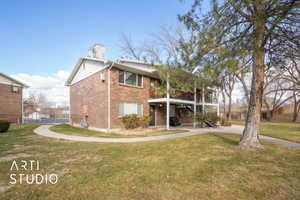 Rear view of property featuring a yard