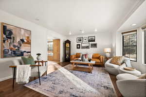 Living room with hardwood / wood-style flooring, a wealth of natural light, and ornamental molding