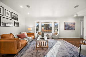 Living room with dark hardwood / wood-style floors and ornamental molding