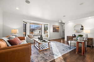 Living room featuring dark hardwood / wood-style flooring and ornamental molding