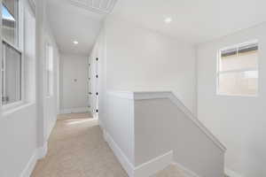 Hallway with light colored carpet