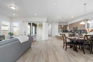 Dining space with a chandelier and light hardwood / wood-style floors