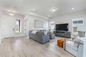 Living room featuring a healthy amount of sunlight and light hardwood / wood-style floors