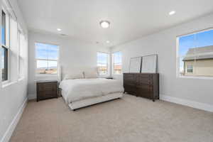 Bedroom featuring light colored carpet