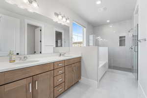 Bathroom featuring tile patterned flooring, vanity, and independent shower and bath