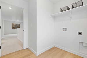 Laundry room featuring washer hookup, wood-type flooring, and electric dryer hookup