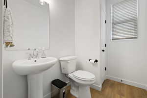 Bathroom featuring hardwood / wood-style flooring and toilet