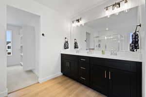 Bathroom featuring vanity, hardwood / wood-style flooring, and walk in shower