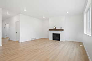 Unfurnished living room featuring light wood-type flooring