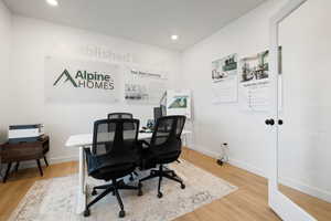 Office area with hardwood / wood-style flooring