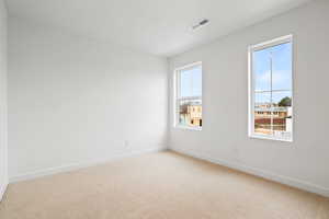 Carpeted spare room with plenty of natural light