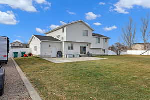 Rear view of house featuring a patio area and a yard