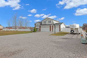 View of front of property with a front yard and a garage