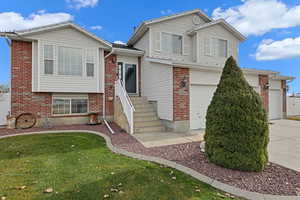 View of front facade with a front yard and a garage