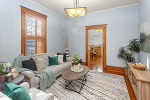 Living room featuring light hardwood / wood-style floors and ornamental molding