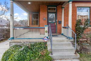 Entrance to property featuring covered porch