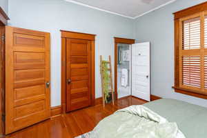 Bedroom featuring wood-type flooring and ornamental molding