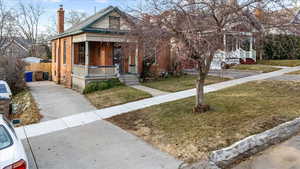 View of front of home featuring a front yard and a porch