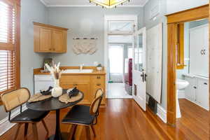 Kitchen with a healthy amount of sunlight, white dishwasher, and light hardwood / wood-style floors