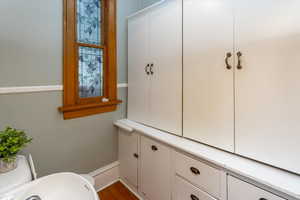 Bathroom with hardwood / wood-style floors and toilet