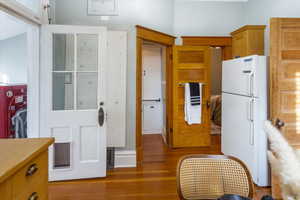 Kitchen featuring dark hardwood / wood-style flooring and white fridge