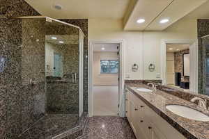 Bathroom with vanity and a shower with shower door