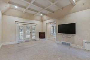 Master Bedroom with a high ceiling, light colored carpet, and a wealth of natural light