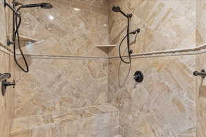 Master Bathroom details featuring a tile shower