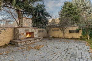 View of patio / terrace with an outdoor stone fireplace