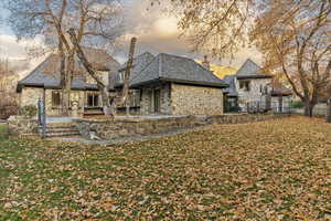 Back house at dusk with a lawn