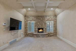 Master Bedroom with a fireplace, beam ceiling, and light carpet