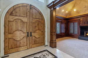 Tiled entrance foyer featuring lofted ceiling