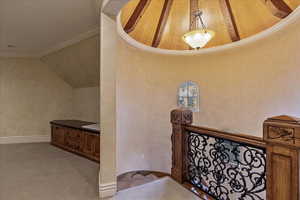 Stairs featuring carpet floors, vaulted ceiling, and ornamental molding