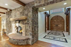 Hallway featuring beam ceiling and light wood-type flooring