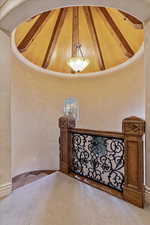 Stairway featuring Utah sandstone, beam ceiling, and high vaulted ceiling